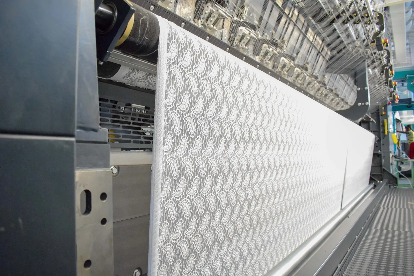 Lace being knitted on a warp-knitting machine